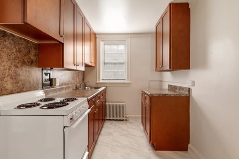 a kitchen with white appliances and wooden cabinets