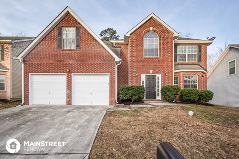 a home with a white garage door in front of it