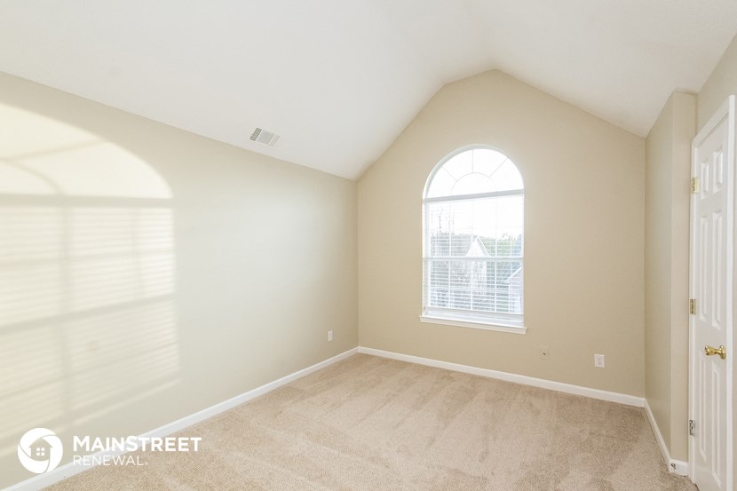 the master bedroom is spacious and has a vaulted ceiling