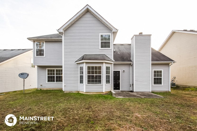 a white house with a yard in front of it