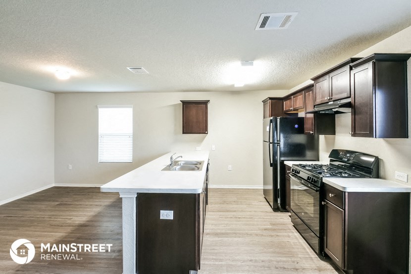a kitchen with black appliances and a white counter top