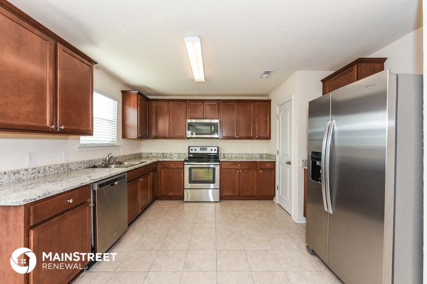 a kitchen with stainless steel appliances and wooden cabinets