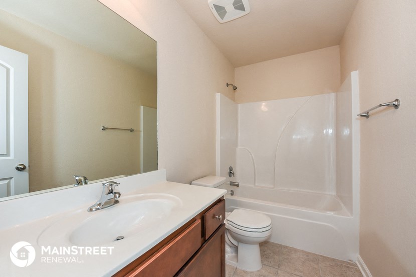 a bathroom with a sink toilet and a tub