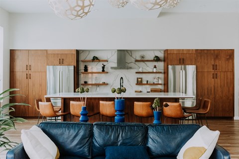 a living room with a leather couch and a table with chairs