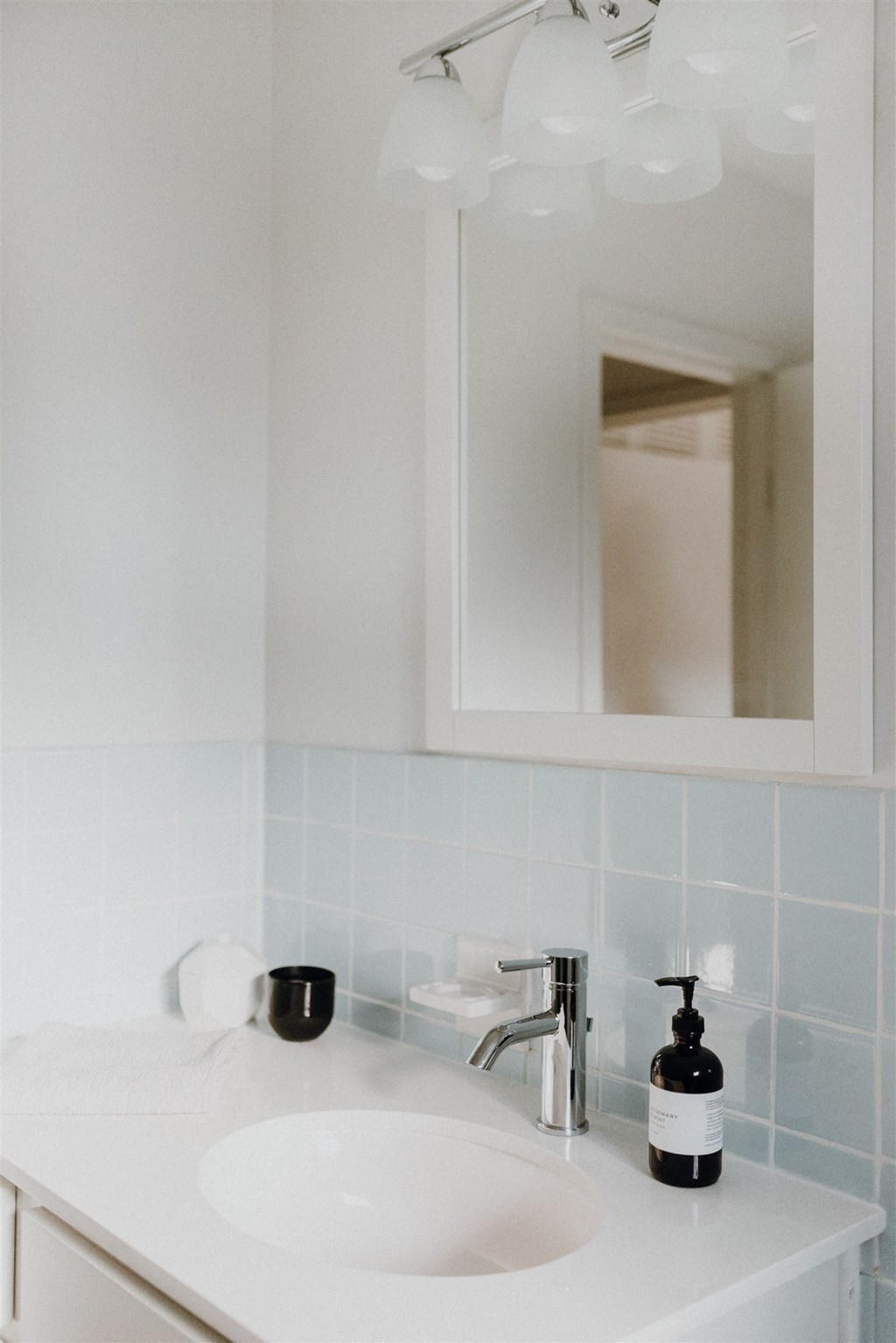 a small bathroom with a sink and a mirror