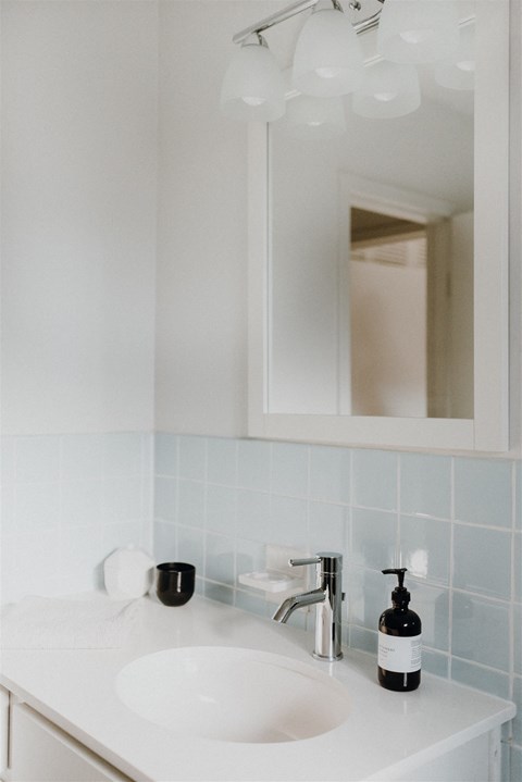 a small bathroom with a sink and a mirror