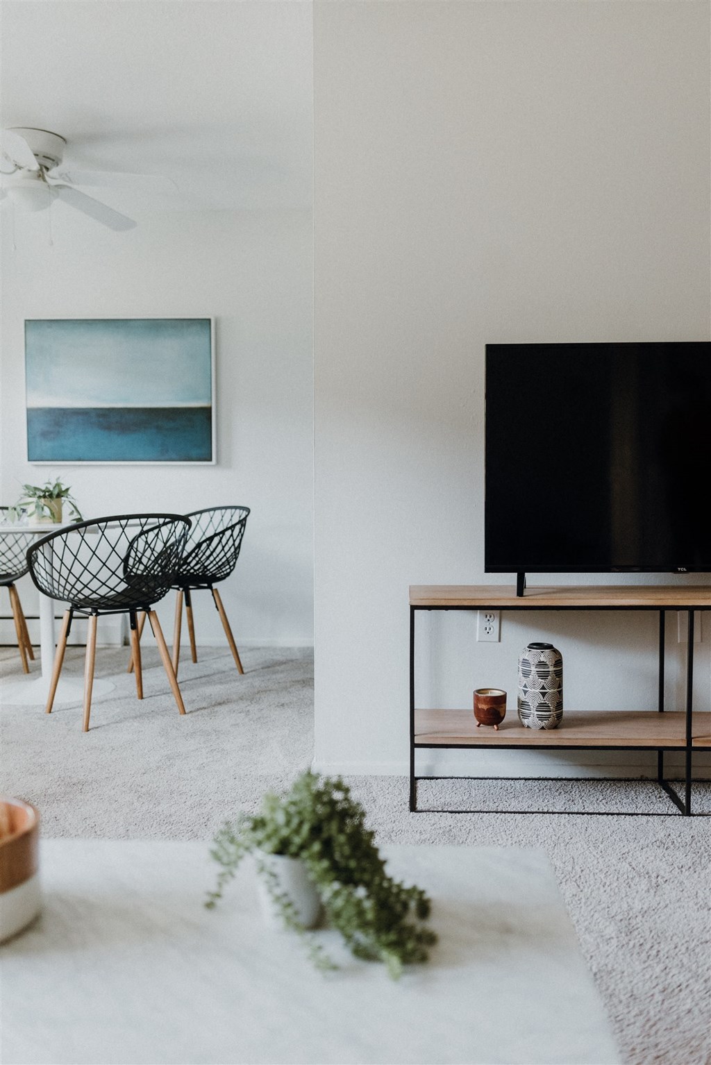 a living room with a tv and a table and chairs