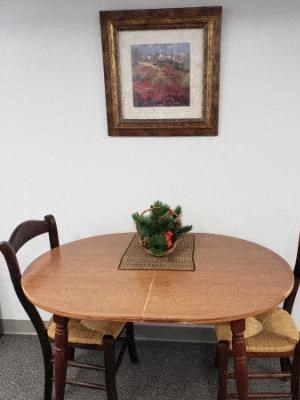 a dining room table with chairs and a centerpiece