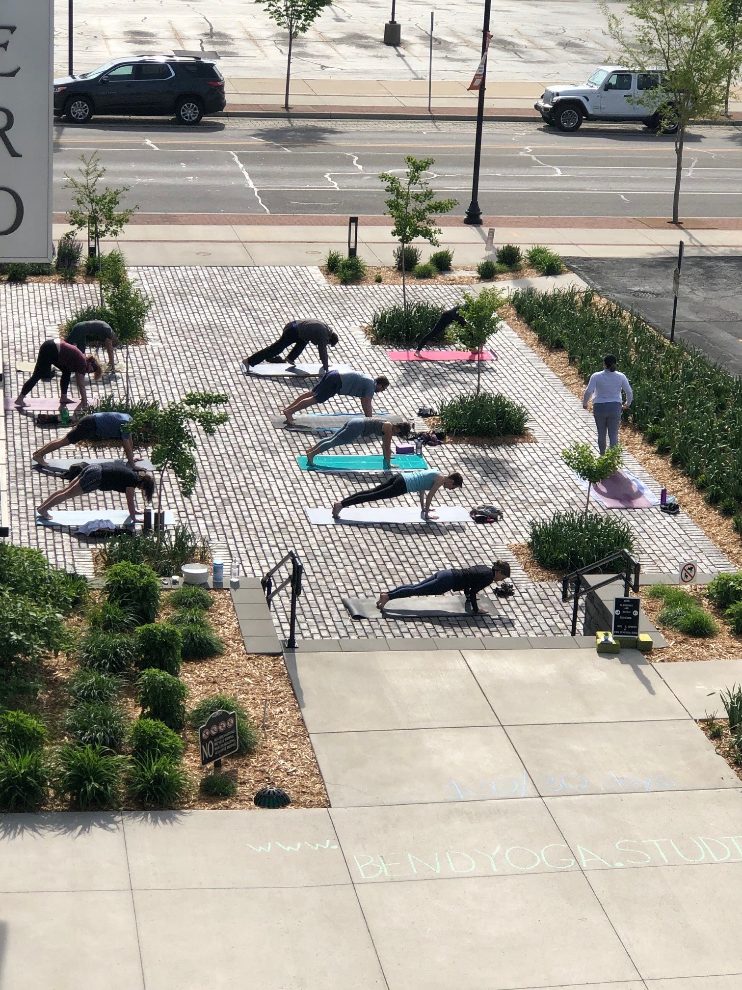 a group of people laying on umbrellas on a sidewalk