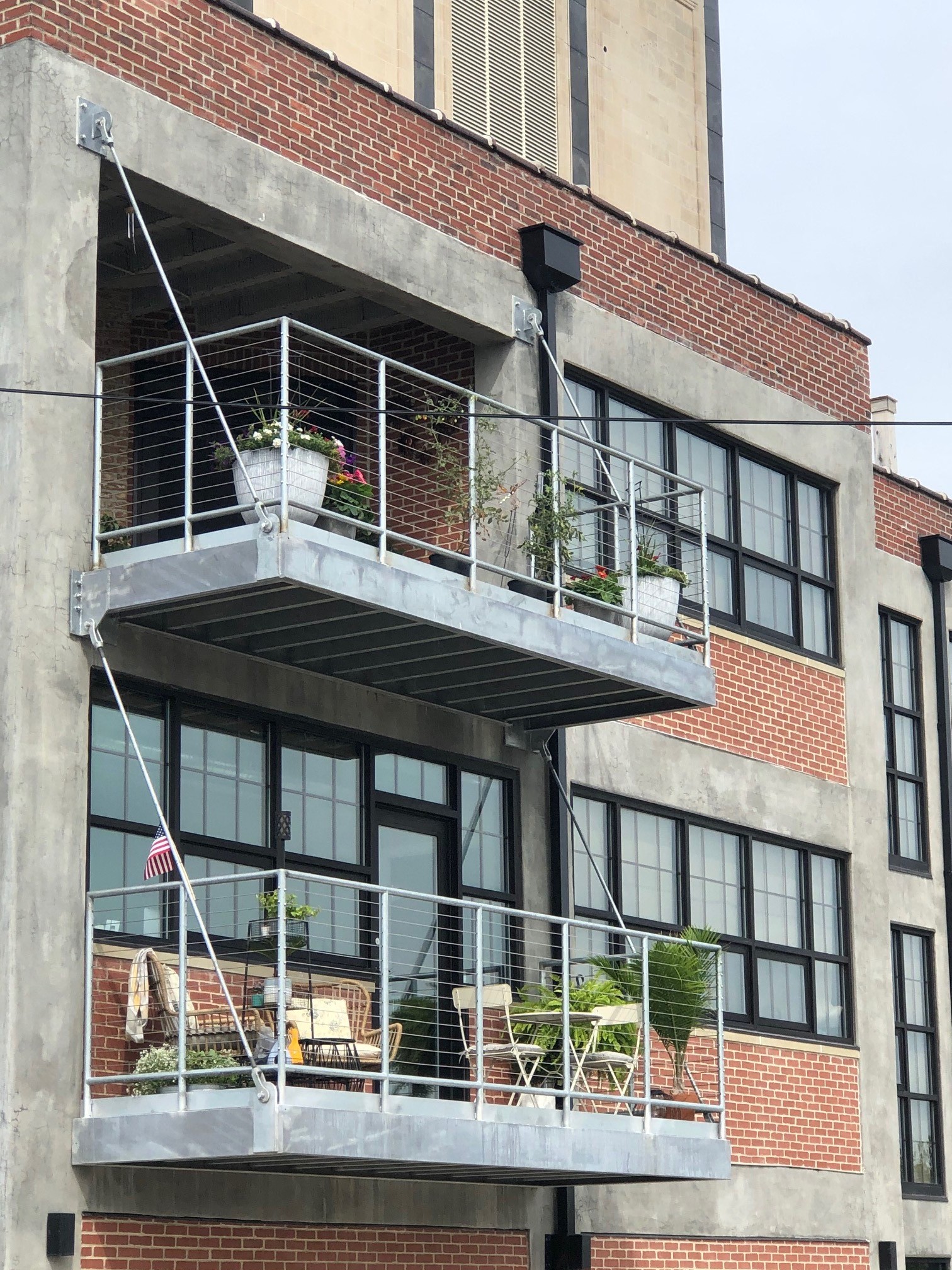 a large brick building with a balcony and a flag