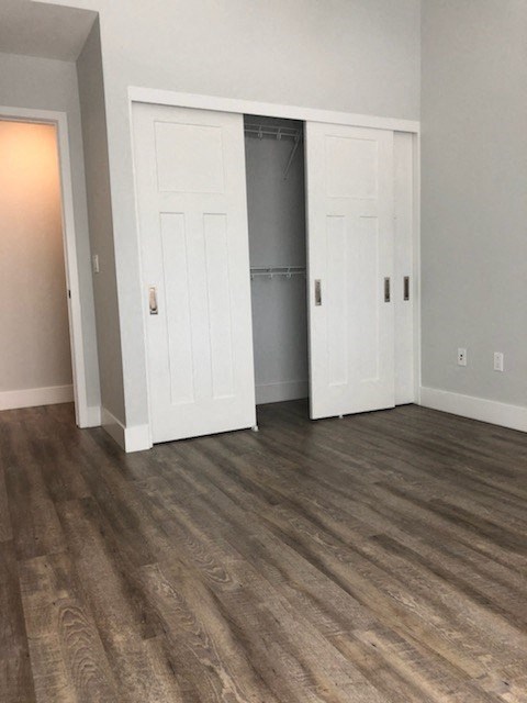 a living room with white doors and a closet