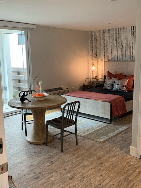 a living room with a bed and a table