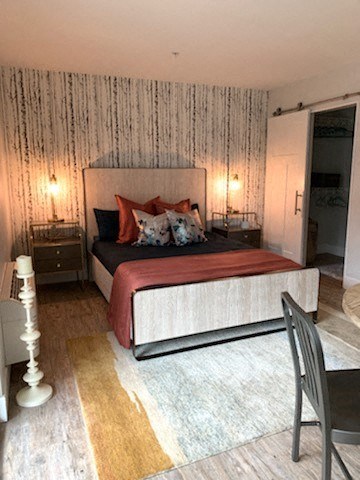 a bedroom with a bed and a table and a chair