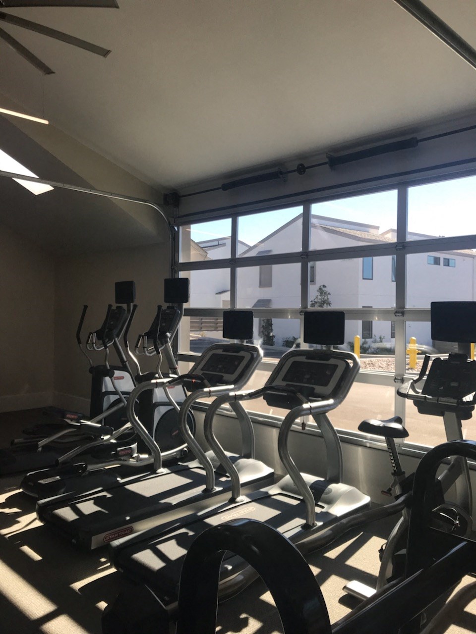 a group of cardio machines in a gym