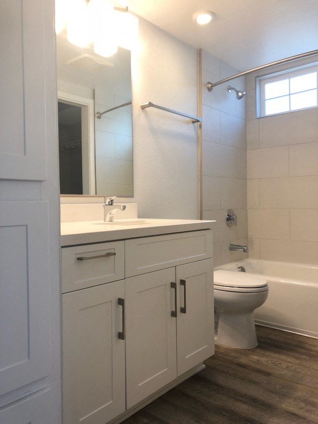 a bathroom with a toilet and a sink and a mirror