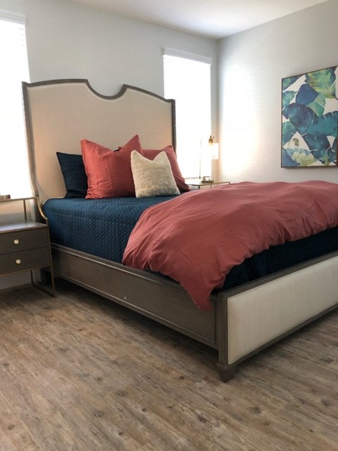 a bedroom with a bed and some pillows on it