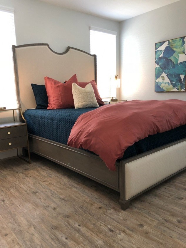 a bedroom with a bed and some pillows on it