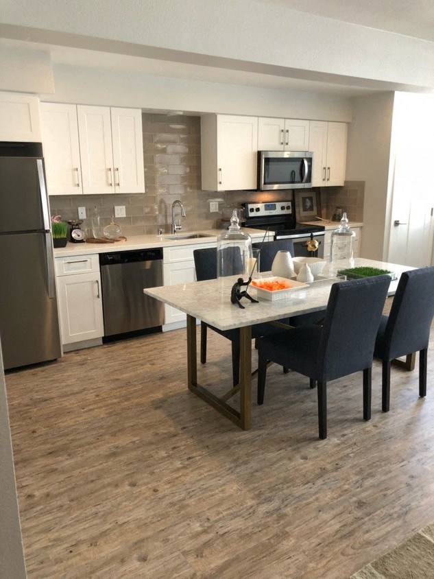 an open kitchen and dining area with a table and chairs
