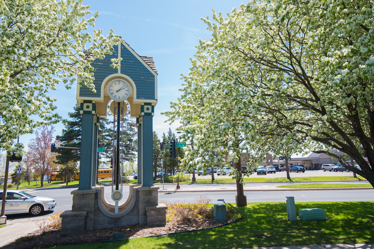 a clock tower in the middle of a park with trees