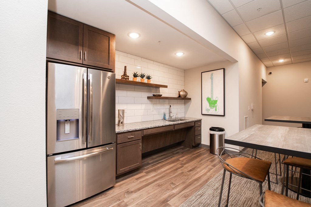 a kitchen with stainless steel appliances and a dining table