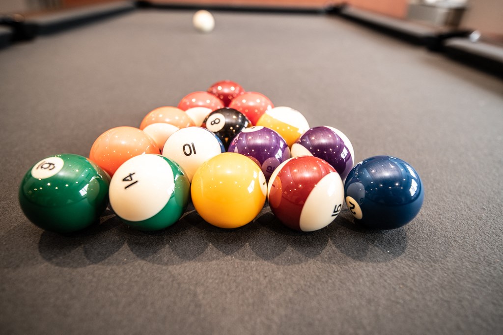 a pile of billiard balls on a pool table