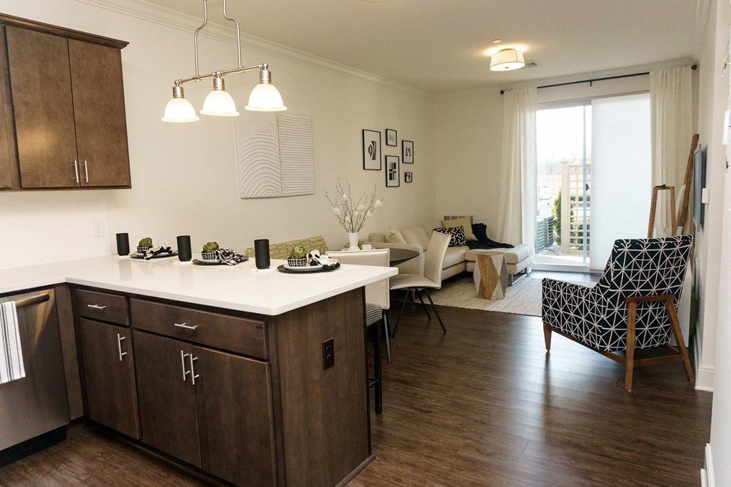 a kitchen and living room with a table and chairs and a window