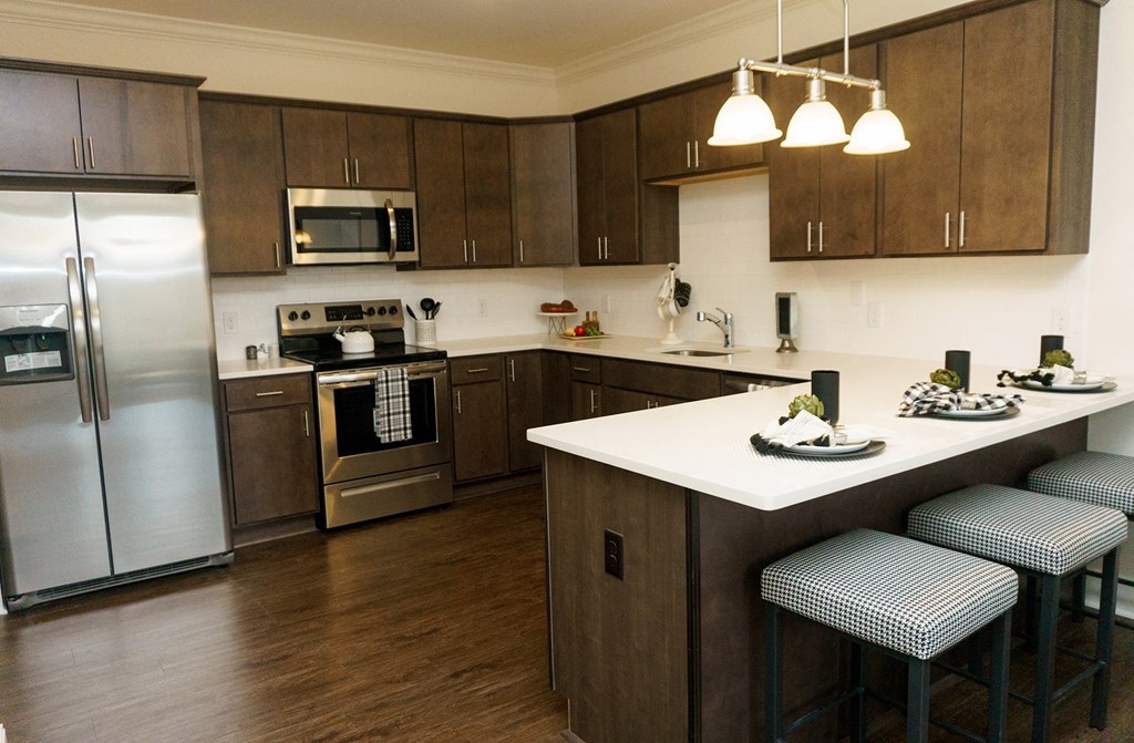 a kitchen with stainless steel appliances and a white counter top