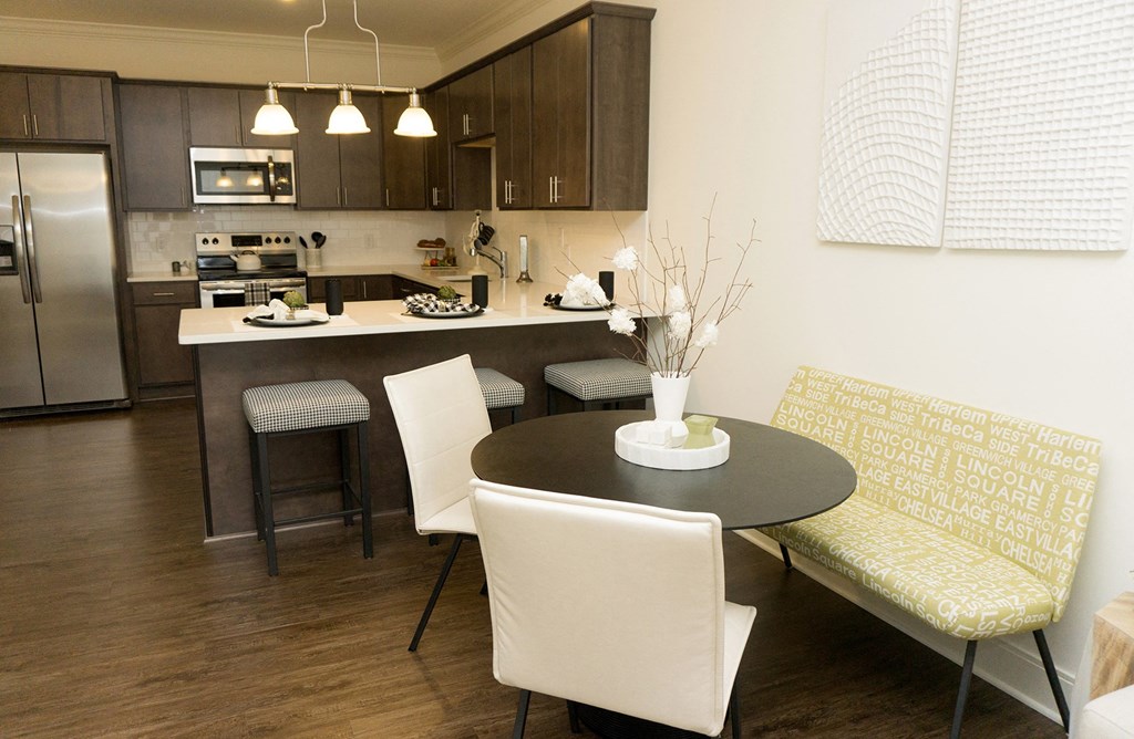 a dining room and kitchen with a table and chairs