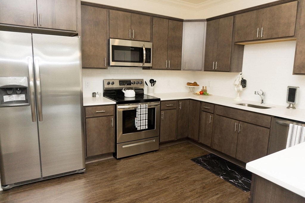 a kitchen with stainless steel appliances and wooden cabinets