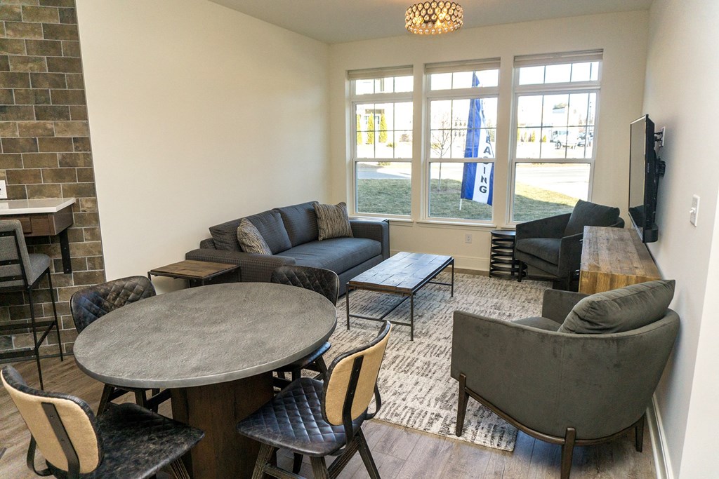 a living room with couches tables and chairs and a fireplace