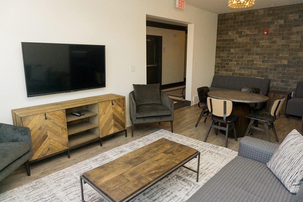a living room with a tv and a table and chairs