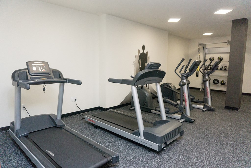 a gym with treadmills and other exercise equipment in a building