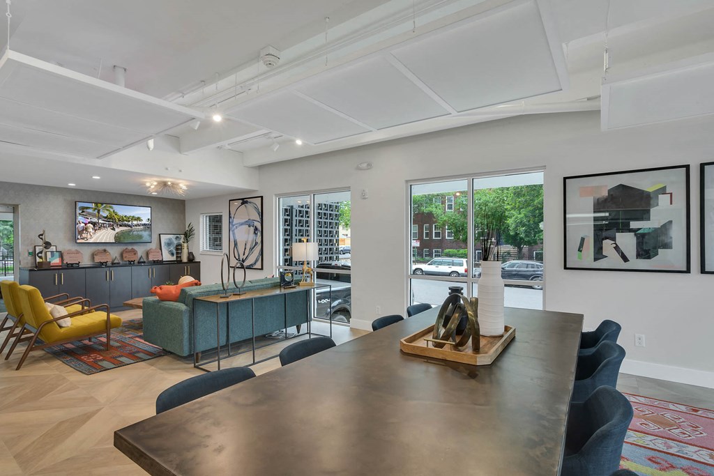 a living room with a dining room table and a kitchen