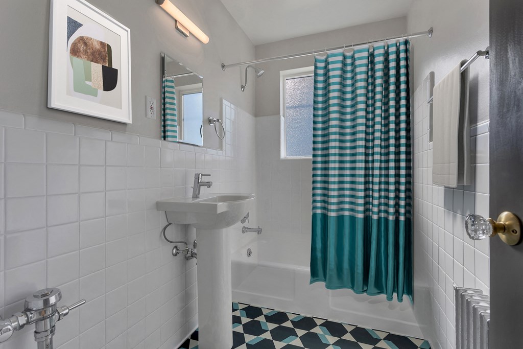 a bathroom with a sink and a shower curtain