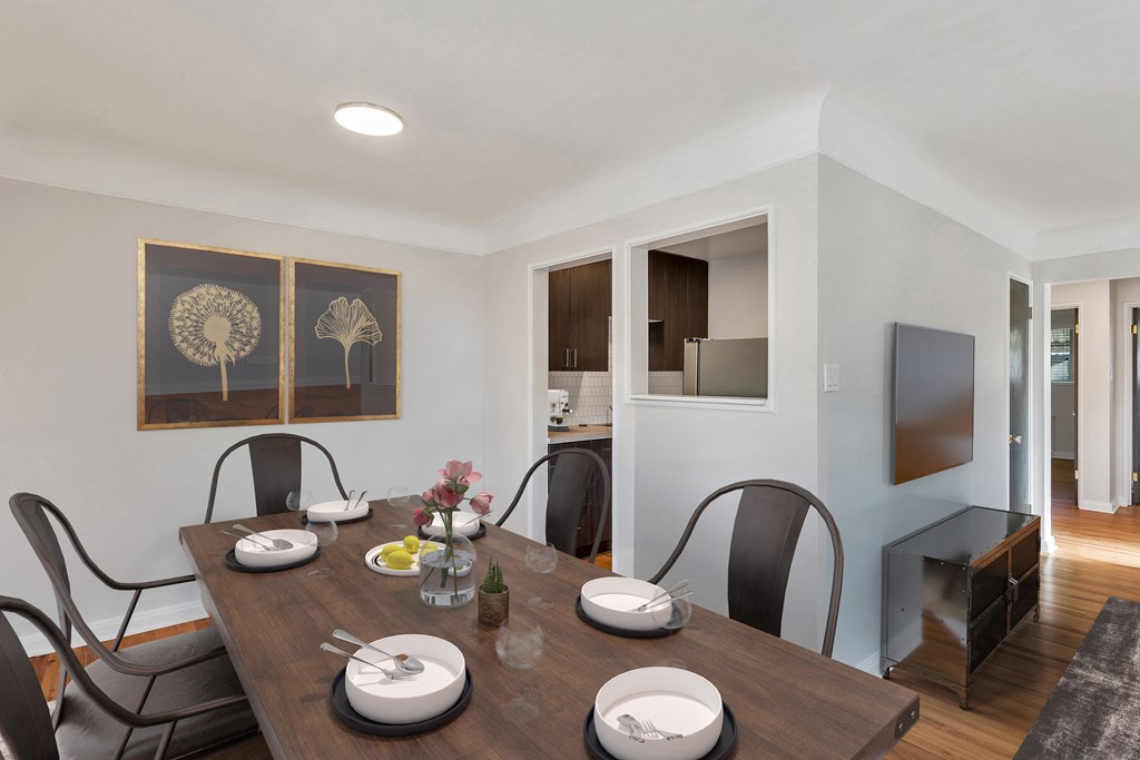 a dining room with a wooden table and chairs