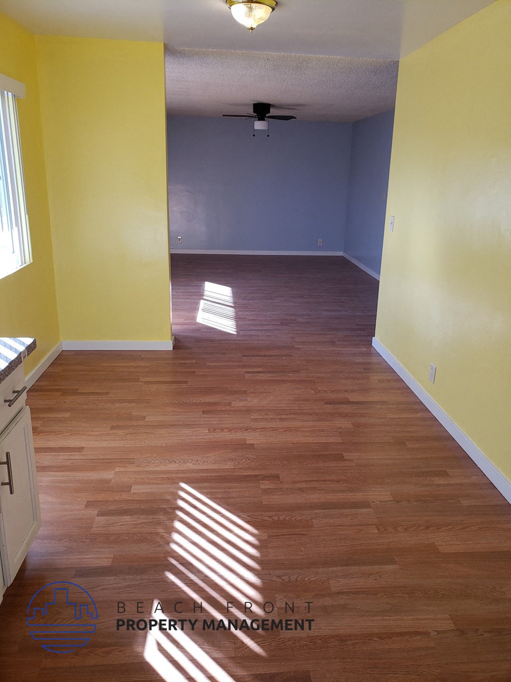 an empty living room with yellow walls and wood floor