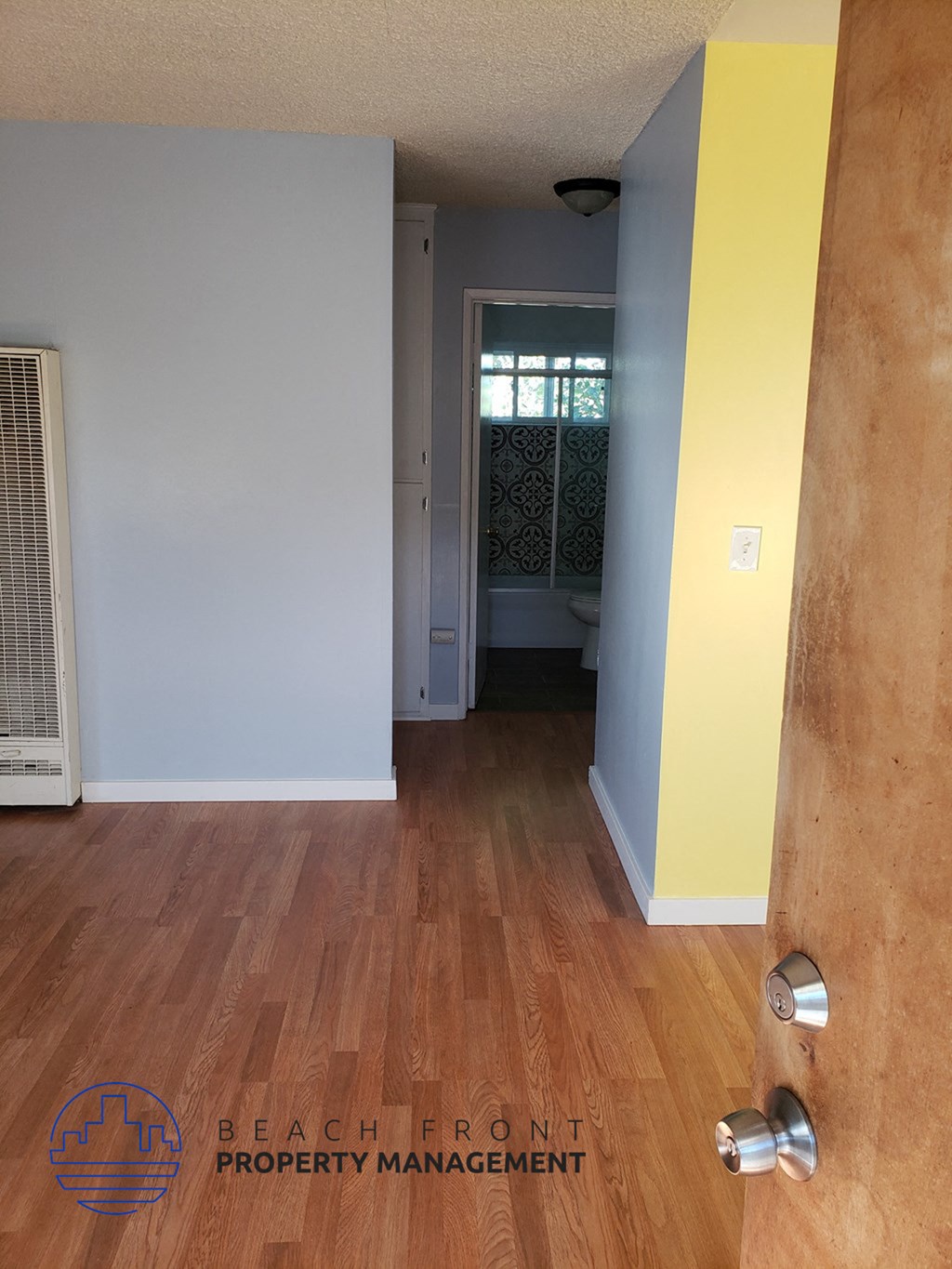 a view of the hallway from the living room looking into the bathroom