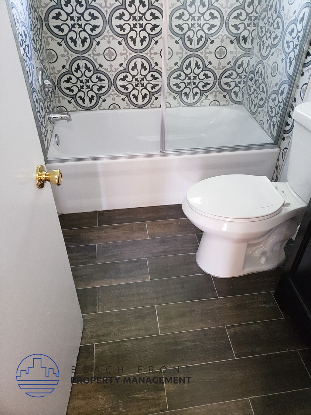 a bathroom with a toilet and a tub and a tiled shower