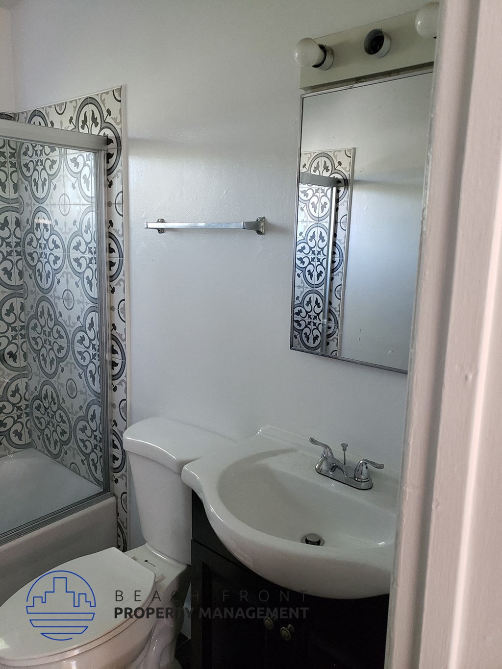 a bathroom with a sink and a toilet and a mirror