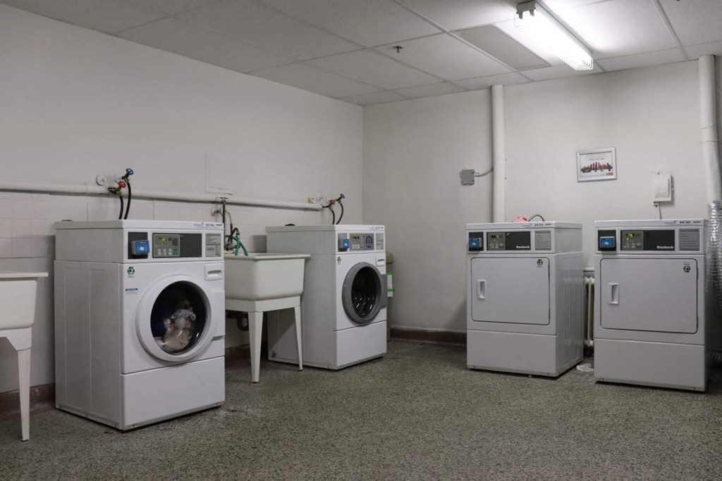 a group of washing machines in a room with other washing machines
