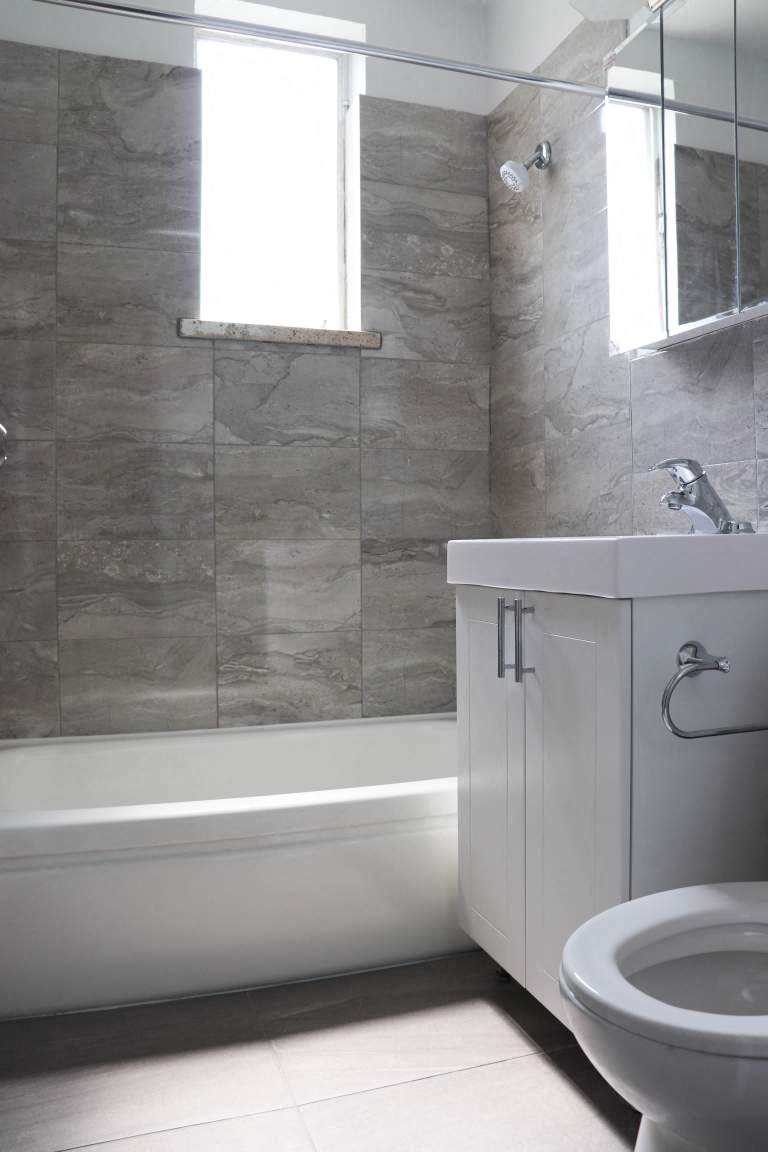 a bathroom with a toilet and a sink and a bath tub