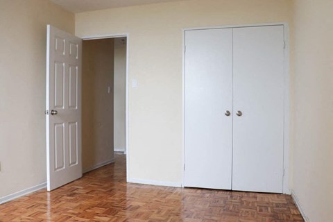 an empty room with a closet and a door