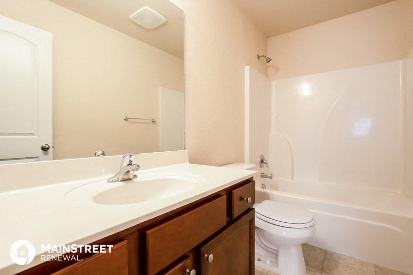 a bathroom with a sink toilet and a bath tub