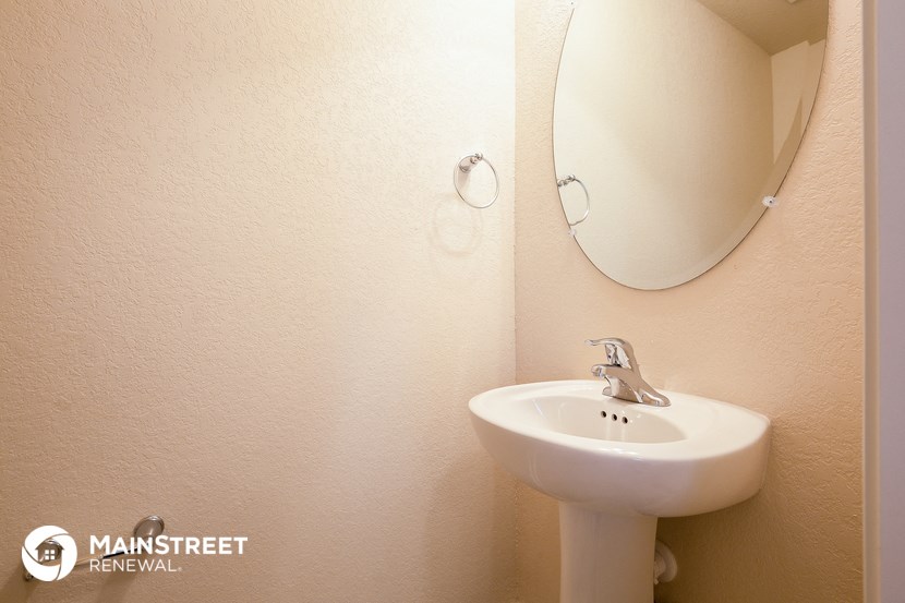 a small bathroom with a sink and a mirror