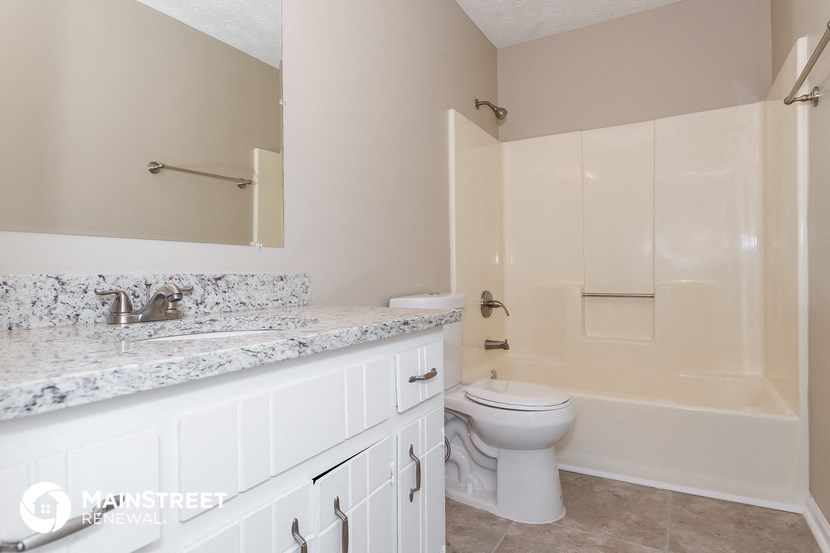 a bathroom with a sink and a toilet and a bath tub