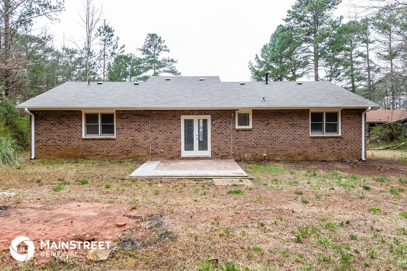 the front of a small brick house with a porch
