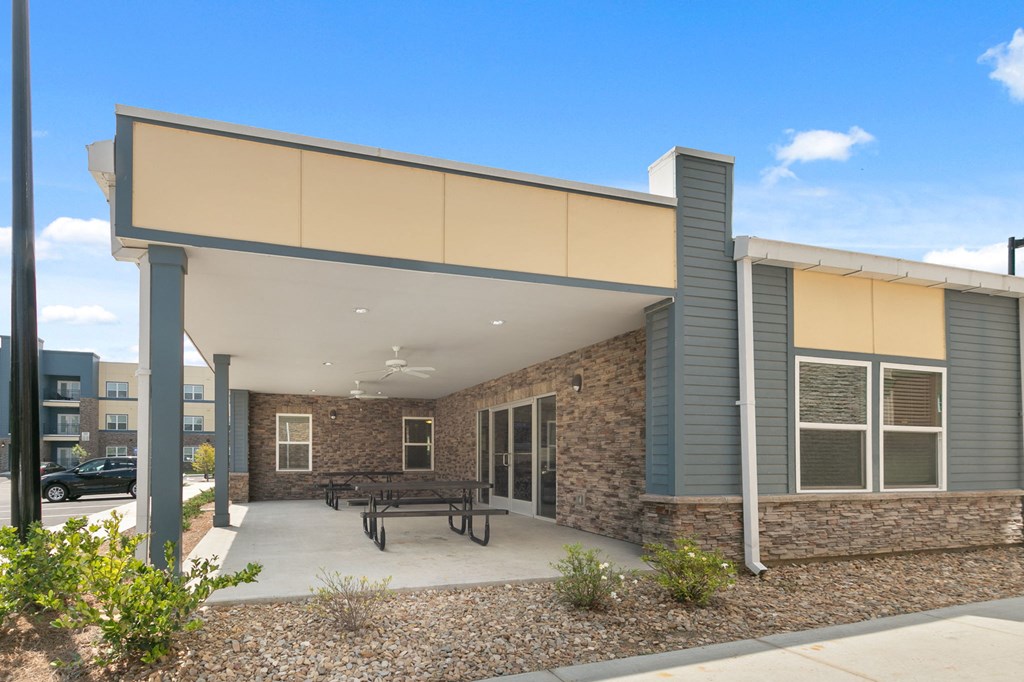 a patio with a picnic table in front of a building