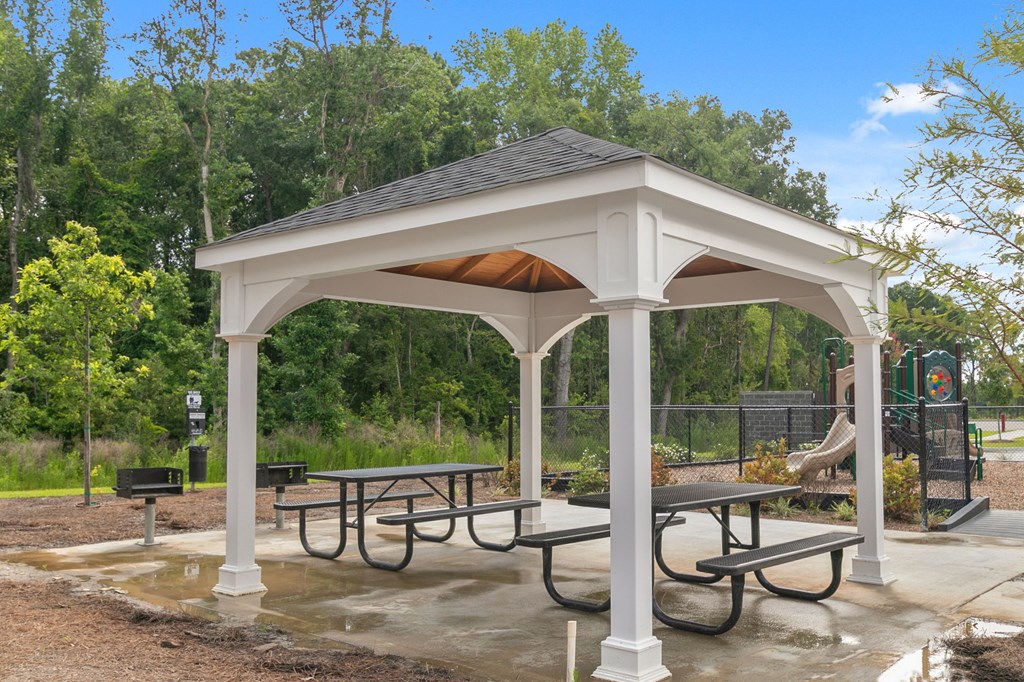 a pavilion with picnic tables at a park