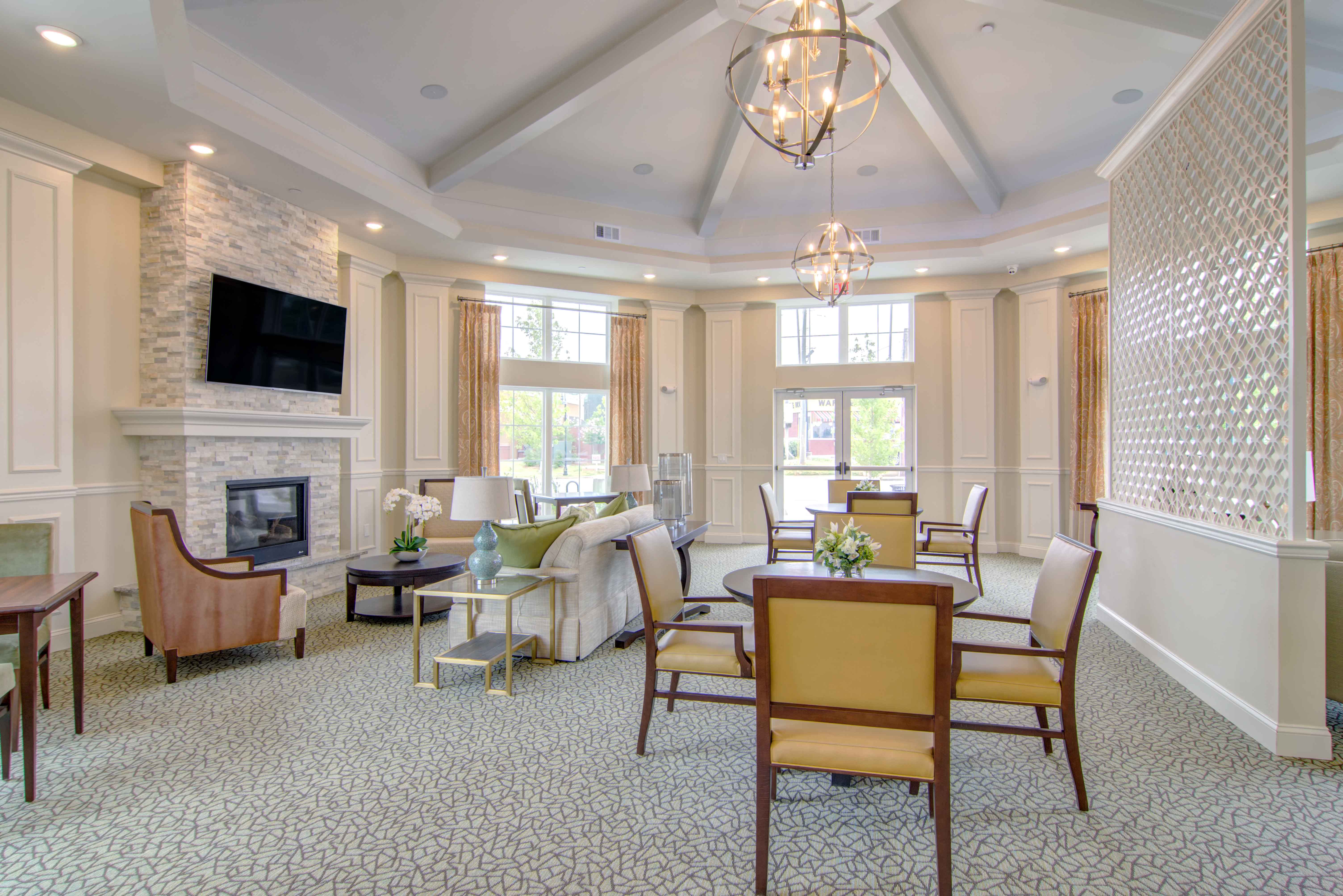 a living room with a table and chairs and a fireplace