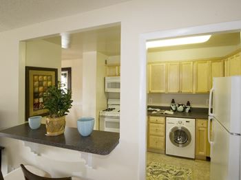 Kitchen appliances include range, refrigerator, dishwasher, and microwave at Trillium Apartments, Fairfax, VA